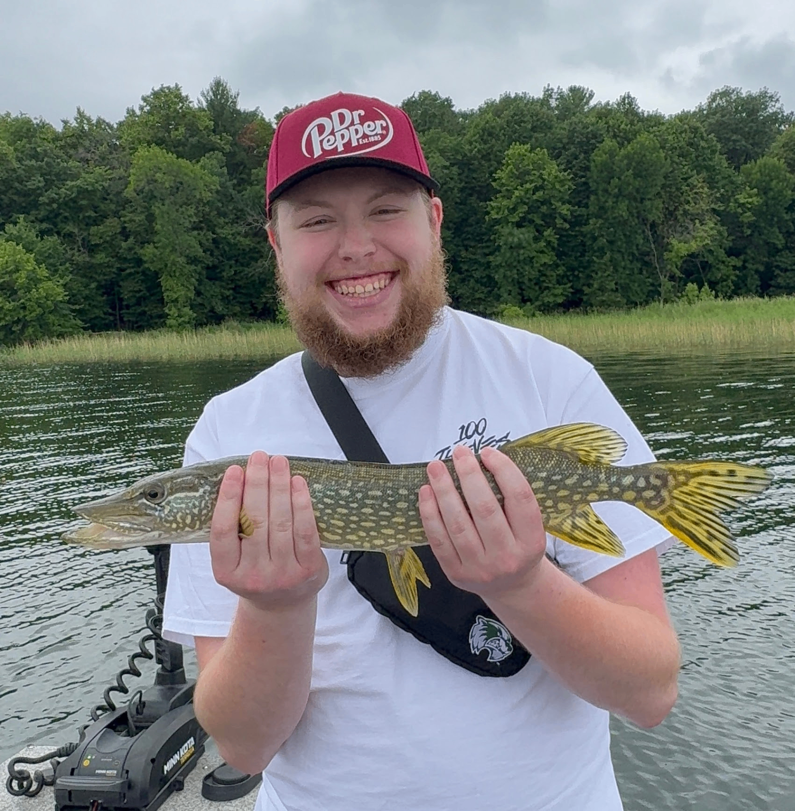 Aidan holding a fish on a lake in Minnesota